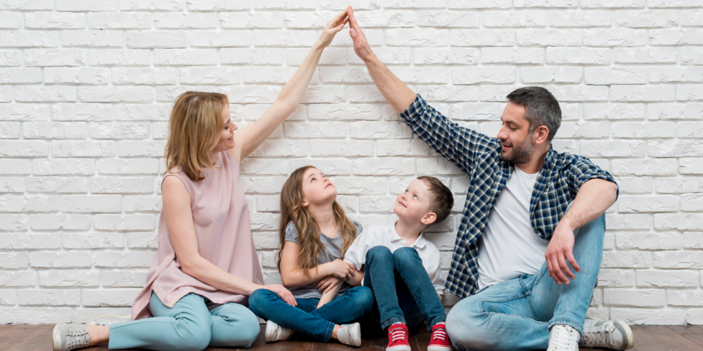 Mother and Father doing a high five with 2 children.